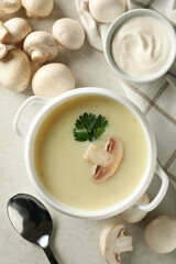 Concept of tasty lunch with bowl of mushroom soup on white background