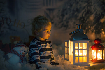 Little boy, looking at flame from match, sitting in the snow