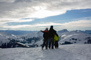 Naklejka na ściany i meble Family, skiing in winter ski resort on a sunny day, enjoying nature