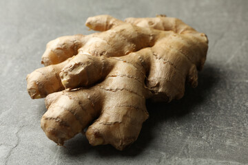 Fresh raw ginger on gray background, close up