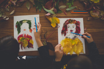 Child, creating woman portrait of leaves in living room, applying leaves using glue