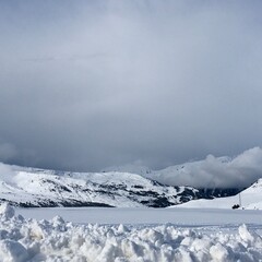 snow covered mountains in the clouds