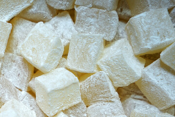 Close up display shelf of Turkish delight (lokum)- confections based on a gel of starch and sugar, Premium varieties consist largely of chopped dates, pistachios, and hazelnuts