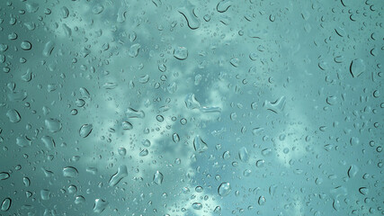 Rain droplets falling on the glass, a rainy day in autumn