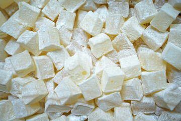 Close up display shelf of Turkish delight (lokum)- confections based on a gel of starch and sugar, Premium varieties consist largely of chopped dates, pistachios, and hazelnuts