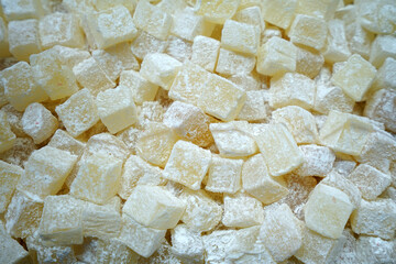 Close up display shelf of Turkish delight (lokum)- confections based on a gel of starch and sugar, Premium varieties consist largely of chopped dates, pistachios, and hazelnuts
