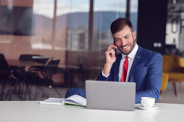 Businessman With Laptop And Smartphone At Office