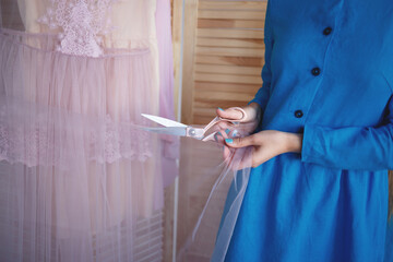 seamstress cuts fabric for sewing boudoir dress