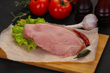 Raw Turkey steak served rosemary