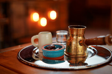 Traditional turkish coffee in cezve on metal tray.