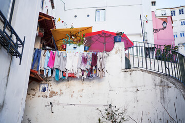 Ancient architecture of old town in Lisbon. Drying clothes.