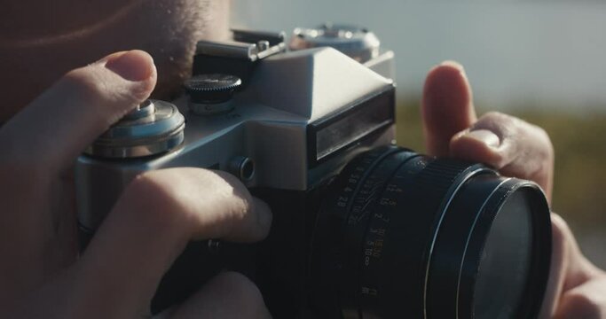 Photographer woman focus manual lens finger press photo camera trigger