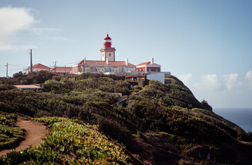 Fototapeta na wymiar Famous lighthouse on Cabo da Roca, the western point of Europe. Beautiful landscape. Day time on the sea shore.