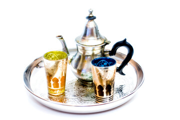 Group of teapot and glasses of oriental tea on a tray on white background