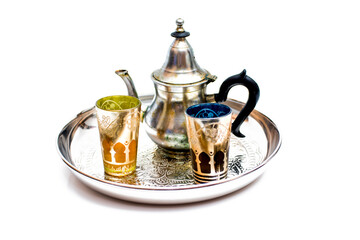 Group of teapot and glasses of oriental tea on a tray on white background