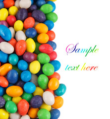 Multicolored candies isolated with space for text