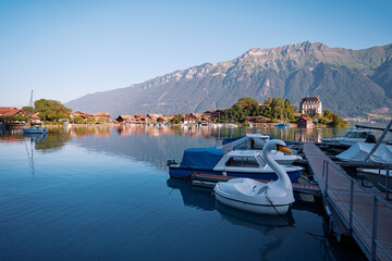 Beautiful swiss landscape. Pier with boats on Brienzersee lake.