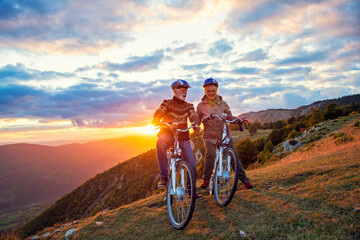 Fototapeta na wymiar Active Senior Couple Riding Bikes In Park