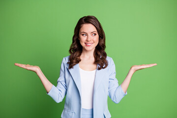 Photo of lady two palms hold look empty space bite lips wear blue blazer isolated green color...