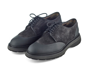 Great pair of brutal men's shoes combined from black suede and waterproof inserts on the toe and heel, on a solid sole, isolated on a white background with shadow.