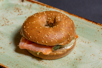 Salmon sandwich in a bun served on a plate