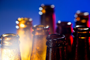 Navy. Neon colored beer bottles, close up isolated on bright studio background. Concept of beer,...