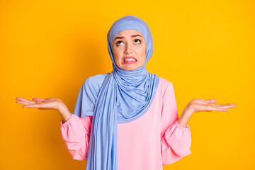 Portrait of attractive moody displeased desperate muslimah wearing hijab looking up isolated on...