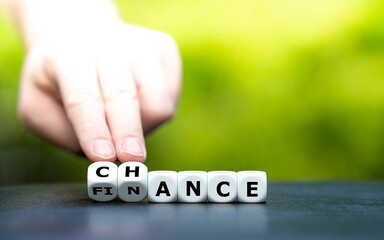 Symbol for a financial chance. Hand turns dice and changes the word "finance" to "chance".