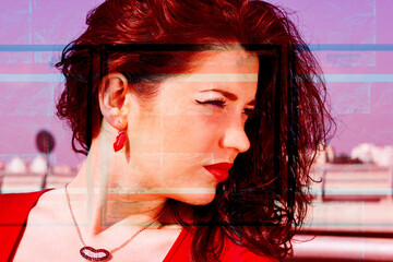 Portrait of a glamorous pretty girl with long red hair. A pretty woman posing on a background of a...