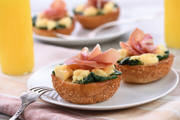 Breakfast. Baked bun with cheese, spinach, prosciutto and orange juice