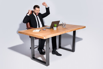 Full length photo of handsome business guy notebook table chatting colleagues read good news...
