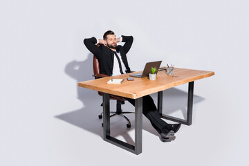 Full length photo of handsome business guy notebook table having break eyes closed hands behind...