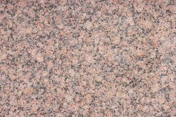 The texture of a variegated speckled polished marble slab.