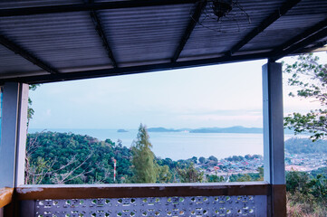 Beautiful view from a hilltop capturing coastal town and it's calming bay. Phuket, Thailand.