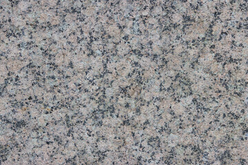 The texture of a variegated speckled polished marble slab.