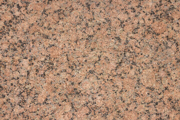 The texture of a variegated speckled polished marble slab.
