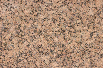 The texture of a variegated speckled polished marble slab.