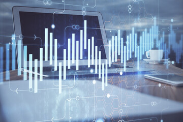 Stock market chart hologram drawn on personal computer background. Double exposure. Concept of...
