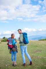 Happy couple hiking and enjoying a valley view