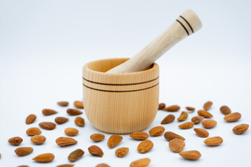 wooden mortar with almonds around