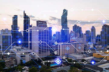 Glowing hologram of technological process, aerial panoramic cityscape of Bangkok at sunset. The...