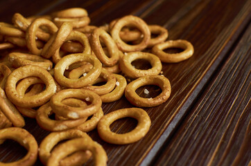 Russian wheat bagels, sushki, baranki with salt on dark rustic table