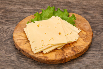 Sliced yellow cheese over board