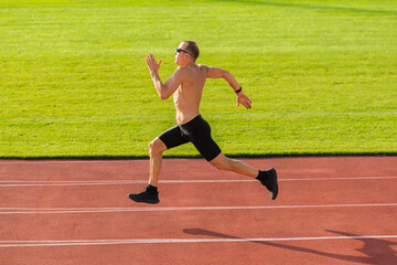 Obraz premium Runner running along the track in the stadium