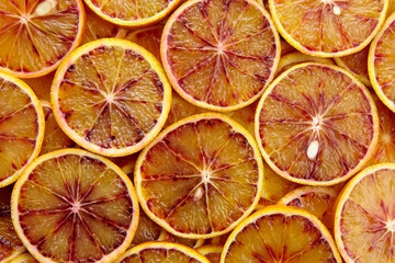 Blood orange slices background, top view. Fresh red orange
