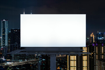 Blank white road billboard with KL cityscape background at night time. Street advertising poster, mock up, 3D rendering. Front view. The concept of marketing communication to promote or sell idea.