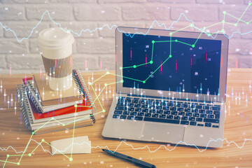Double exposure of graph and financial info and work space with computer background. Concept of...