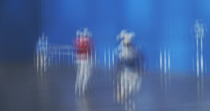 Abstract Shot Of A Basque Pelota Player In Blue Uniform Running At The Game Court With A Bat - slow motion