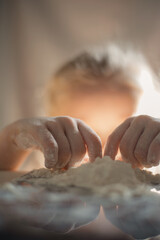 girl playing with flour. Close-up portrait of a girl playing with flour