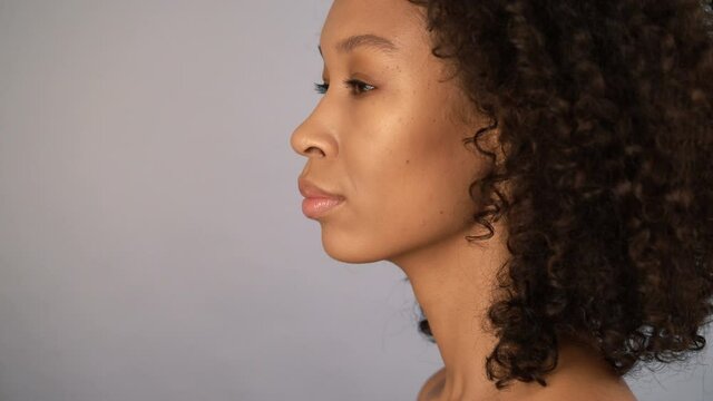 profile portrait. beautiful female african american woman face on gray isolated background. 4k